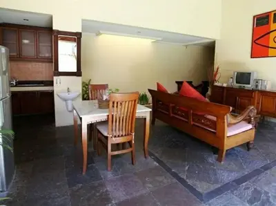 a kitchen with a couch and a table and chairs at Clasic Private Pool Villa in Seminyak in Seminyak