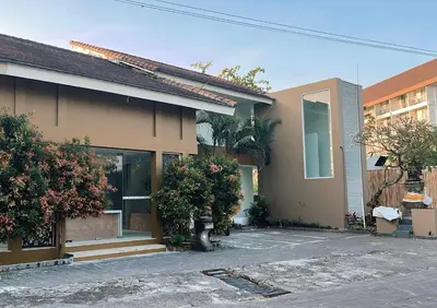 a house with a parking lot in front of it at Astana Residence in Seminyak