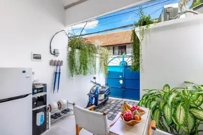a patio with a blue door and a table and a scooter at The Blue Loft Seminyak free scooter in Seminyak