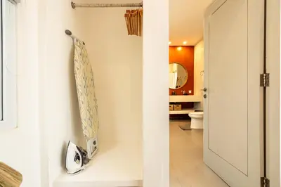 a bathroom with a toilet and a mirror at Bloom Umalas Villa by Betterplace in Canggu