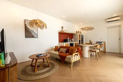 a living room with a couch and a table at Bloom Umalas Villa by Betterplace in Canggu