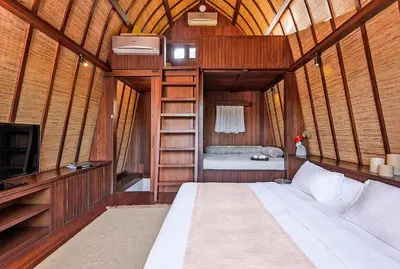 a bedroom with a bed and a tv in a room at LataLiana Seminyak in Seminyak