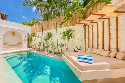 a swimming pool with aitating room and a villa at Villa San Diego: Brand New 4BDR in Seminyak