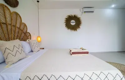 a bedroom with a bed with white sheets and pillows at Simple & Magical Villas Almaya 2 in Canggu