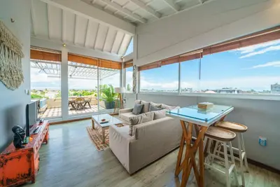 a living room with a couch and a table at Private Penthouse with Sunset Views Central Seminyak in Seminyak