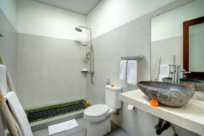 a bathroom with a sink and a toilet at Villa O'Anne in Seminyak