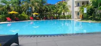 a large blue swimming pool in a hotel at The Bay Sunflower Apartment in Nusa Dua