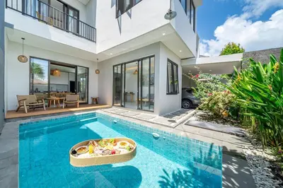 a swimming pool in a house with a house at TC Villa Taman Mumbul Nusa Dua in Nusa Dua