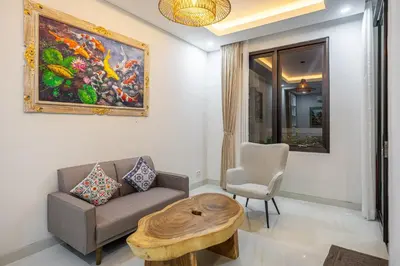 a living room with a couch and a table at TC Villa Taman Mumbul Nusa Dua in Nusa Dua