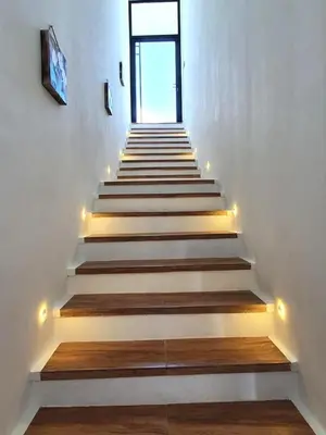 a stairway with lights and white walls and a window at Villa Athalla - Elegant 3BR Near Berawa Beach! in Canggu