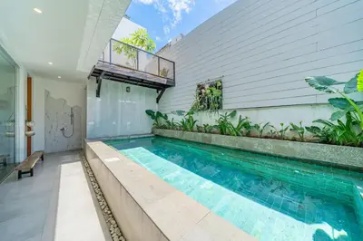 a swimming pool in the middle of a house at Villa Athalla - Elegant 3BR Near Berawa Beach! in Canggu