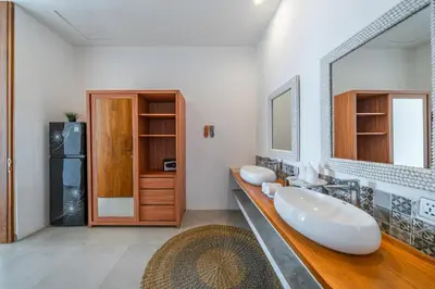 a bathroom with two sinks and a large mirror at Villa Athalla - Elegant 3BR Near Berawa Beach! in Canggu