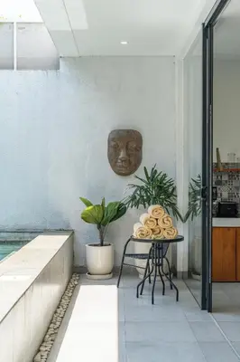 a room with a table with a head on the wall at Villa Athalla - Elegant 3BR Near Berawa Beach! in Canggu