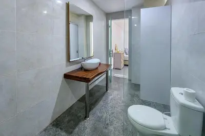 a bathroom with a sink and a toilet at Villa Emilia Seminyak by Nagisa Bali in Kerobokan