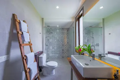 a bathroom with a sink and a toilet and a shower at Villa Emilia Seminyak by Nagisa Bali in Kerobokan