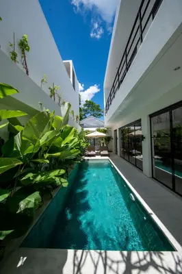 an image of a swimming pool in front of a house at Two-Bedroom Pool Villa at Anwa Residences in Canggu