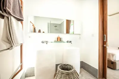 a white room with a bed and a mirror at New Brawah 5 BR Villa 200m to Finns Beach Club in Canggu