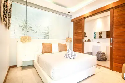 a bedroom with a white bed and a large window at New Brawah 5 BR Villa 200m to Finns Beach Club in Canggu