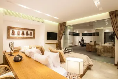 a living room with a white couch and a table at New Brawah 5 BR Villa 200m to Finns Beach Club in Canggu