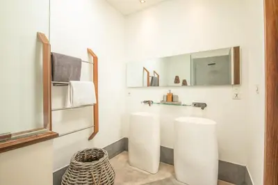 a bathroom with two white toilets and a mirror at New Brawah 5 BR Villa 200m to Finns Beach Club in Canggu