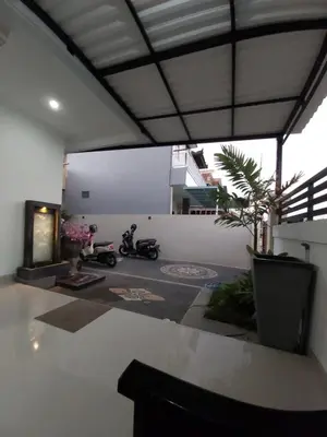 a room with two motorcycles parked in it at Chandra's House in Denpasar