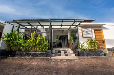 a house with a glass door and some plants at Little Boutique Hotel No 101 in Canggu