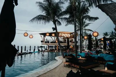 a pool at a resort with people swimming in it at Little Boutique Hotel No 101 in Canggu