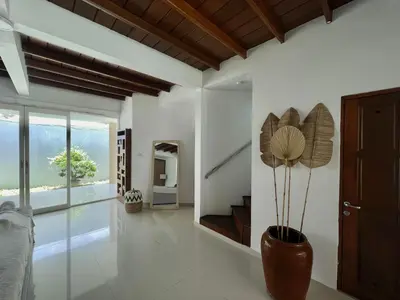 a living room with a vase with a plant in it at Mila's Villa in Legian