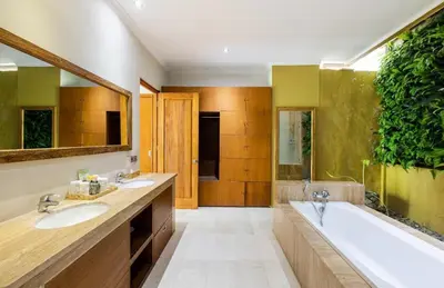 a bathroom with two sinks and a bath tub at Zolina Villa 4 Bedrooms in Kerobokan