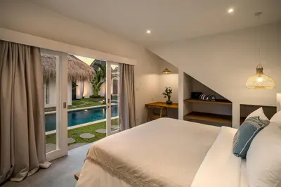a bedroom with a bed and a view of a pool at Villa Makena by Alfred in Bali in Seminyak