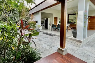 an open living room and dining room with plants at Villa Plawa in Seminyak