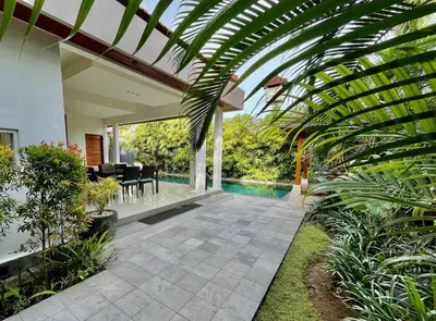 a house with a conservatory with a swimming pool at Villa Plawa in Seminyak