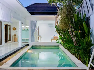 a swimming pool in the middle of a house at Villa between seminyak & canggu in Seminyak