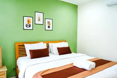 a bedroom with two beds with green walls at Villa between seminyak & canggu in Seminyak