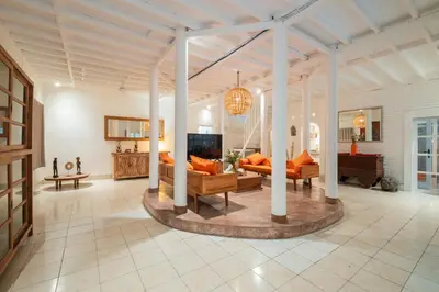 a large living room with couches and a tv at Seminyak Villa Kubuku in Seminyak