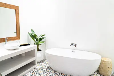 a bathroom with a large white tub and a sink at Villa Amil Seminyak in Seminyak