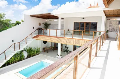 an image of a house with a balcony and a swimming pool at Villa Amil Seminyak in Seminyak