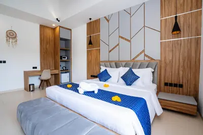 a bedroom with a large white bed with blue accents at Villa Waldo - 6 bedroom High End Luxury Villa in Batu Belig, Seminyak in Canggu