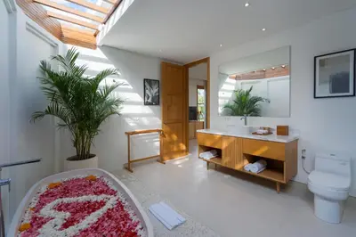 a bathroom with a tub and a sink and a toilet at Amenara Estate by LifestyleRetreats in Canggu