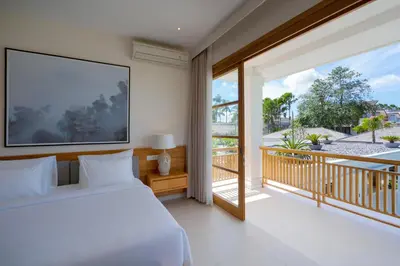 a bedroom with a bed and a balcony at Amenara Estate by LifestyleRetreats in Canggu