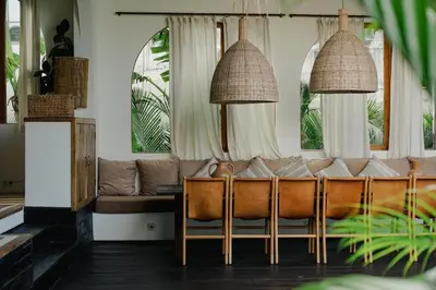 a living room with a couch and windows at Villa Micasa - Tropical Oasis 4BR Villa with Private Pool, Perfect for Big Groups, 12 Minutes to the Beach in Kerobokan