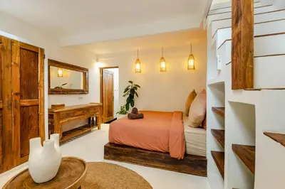 a bedroom with a bed and a desk at Villa Micasa - Tropical Oasis 4BR Villa with Private Pool, Perfect for Big Groups, 12 Minutes to the Beach in Kerobokan