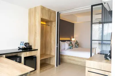 a small bedroom with a bed and a glass door at Anagata 3 Tanjung Benoa Bali in Nusa Dua
