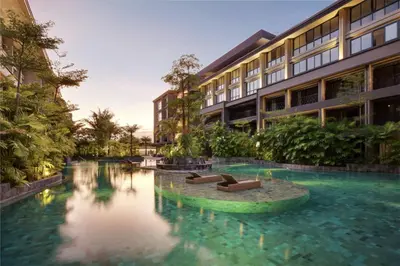 a swimming pool in front of a building at Anagata 3 Tanjung Benoa Bali in Nusa Dua
