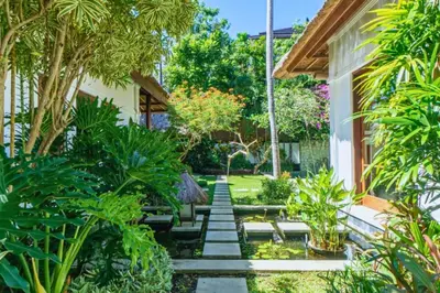a garden with a stone pathway with plants at Magnificent 4 BR Private Pool Villa NE10 in Jimbaran