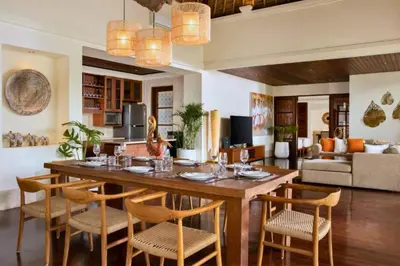 a dining room and living room with a table and chairs at Mandevilla 4 BR Private Pool Villa NE25 in Jimbaran