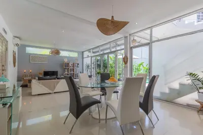 a living room with a glass table and chairs at Cosy 3 BR villa with private pool in Seminyak in Seminyak
