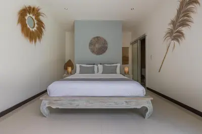 a bedroom with a large bed and a bench at Cosy 3 BR villa with private pool in Seminyak in Seminyak