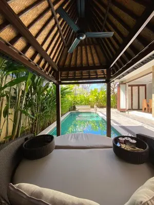 a pergola with a swimming pool in a house at Villa Granatlia in Sanur