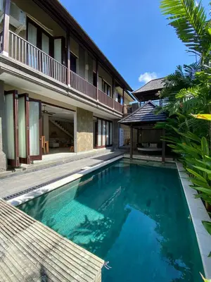 a swimming pool in front of a villa at Villa Granatlia in Sanur